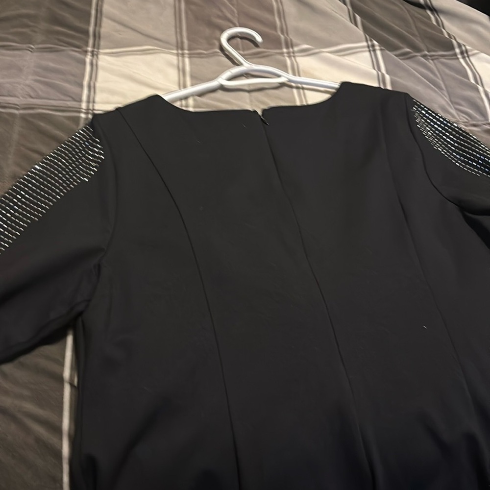 Black dress with sequins on the sleeves, knee length